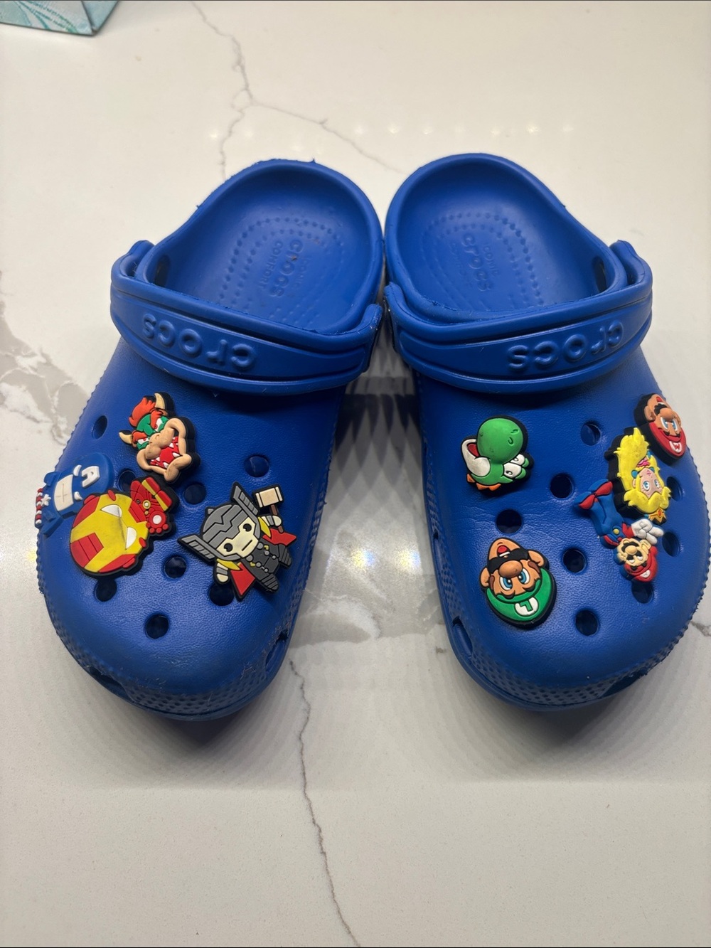 Child’s blue Crocs with charms